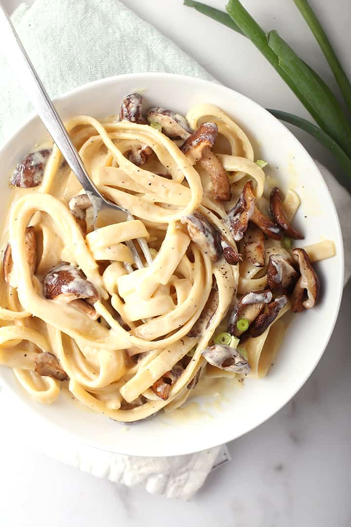 Plate of vegan Alfredo pasta with fork