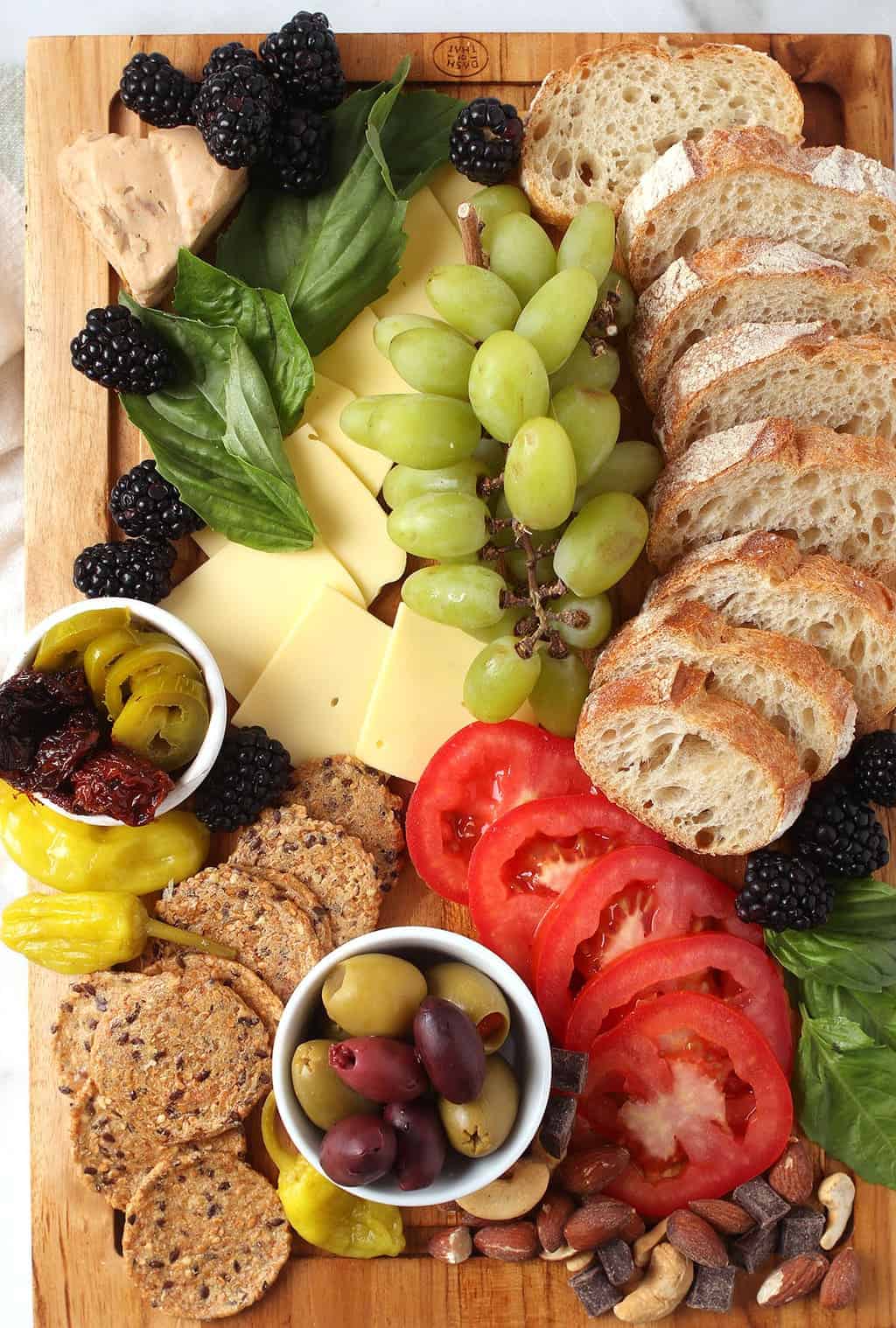 Finished charcuterie board on wooden platter