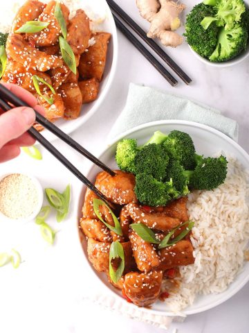 Finished recipe on a white plate with chopsticks