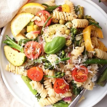 Vegan pasta on a white plate with a fork