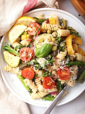 Vegan pasta on a white plate with a fork