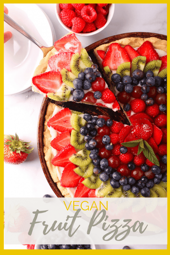 Vegan Fruit Pizza! It is made with a buttery, melt-in-your-mouth sugar cookie crust, topped with sweet cream cheese filling, and finished with fresh fruit for the perfect summertime dessert.