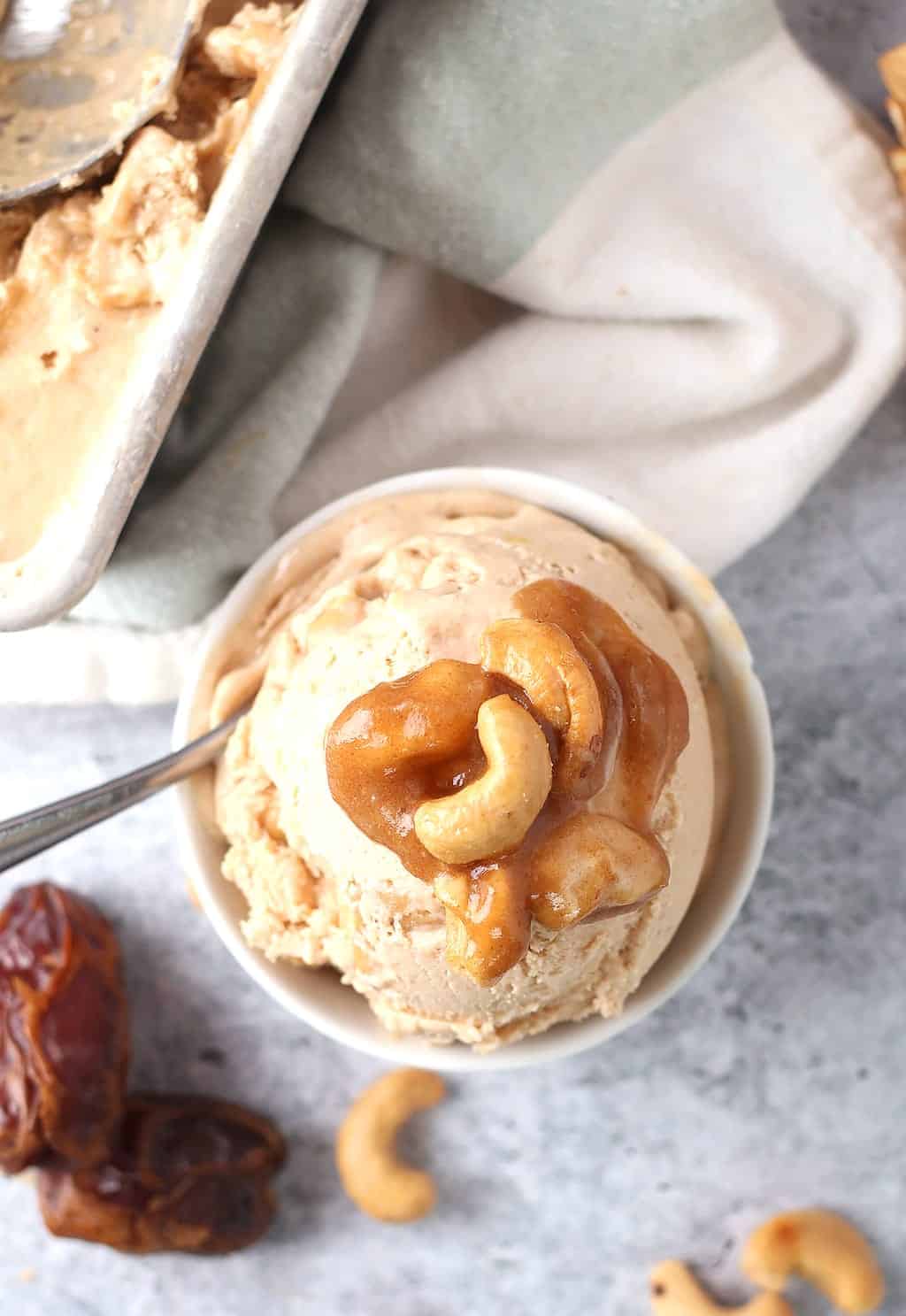 Salted Cashew Ice Cream w/ Caramel Ripple 2 Ingredients for recipe in small bowls on a concrete slab