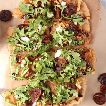 Vegan grilled flatbread topped with arugula and figs
