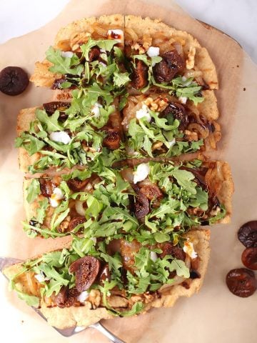 Vegan grilled flatbread topped with arugula and figs