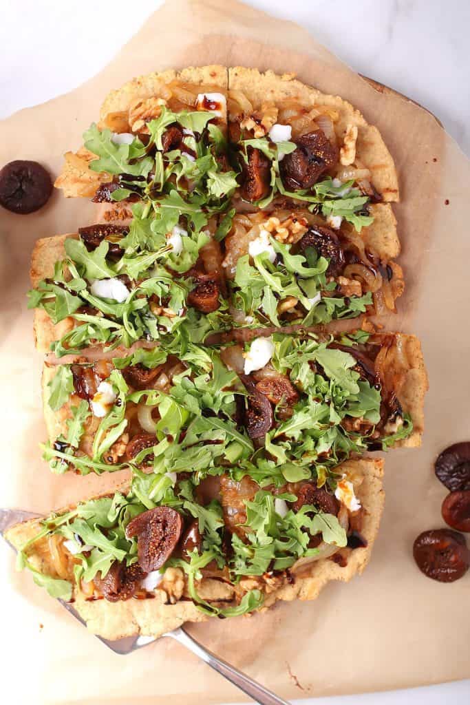 Vegan grilled flatbread topped with arugula and figs