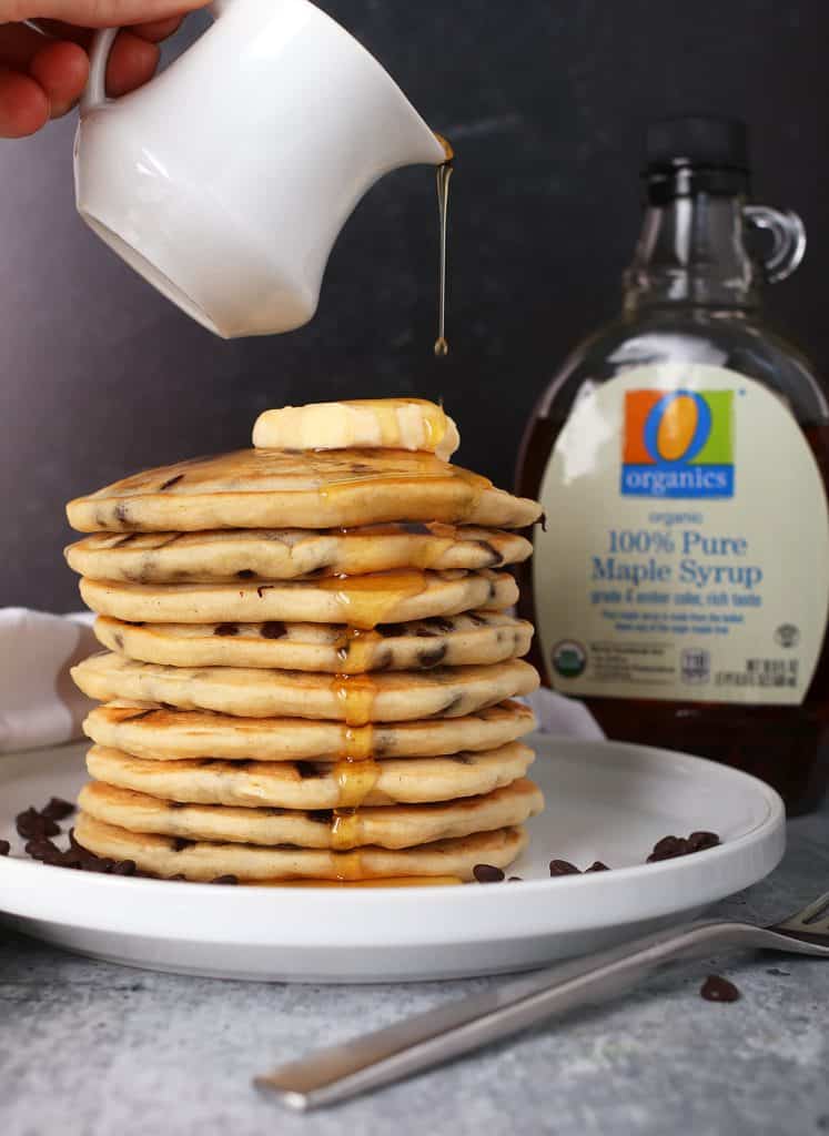 Stack of finished pancakes on a white plate