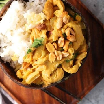 Finished dish served over rice in a coconut bowl