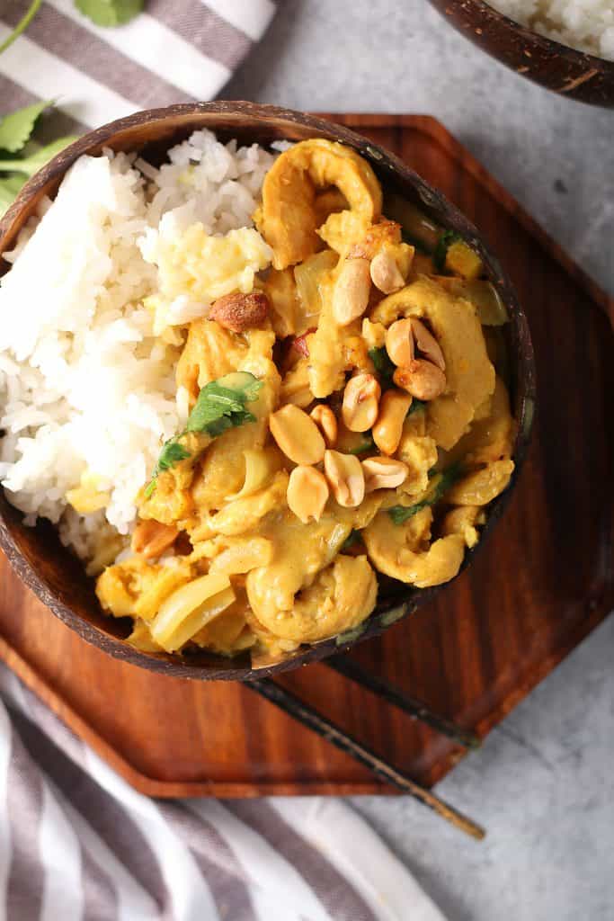 Finished dish served over rice in a coconut bowl