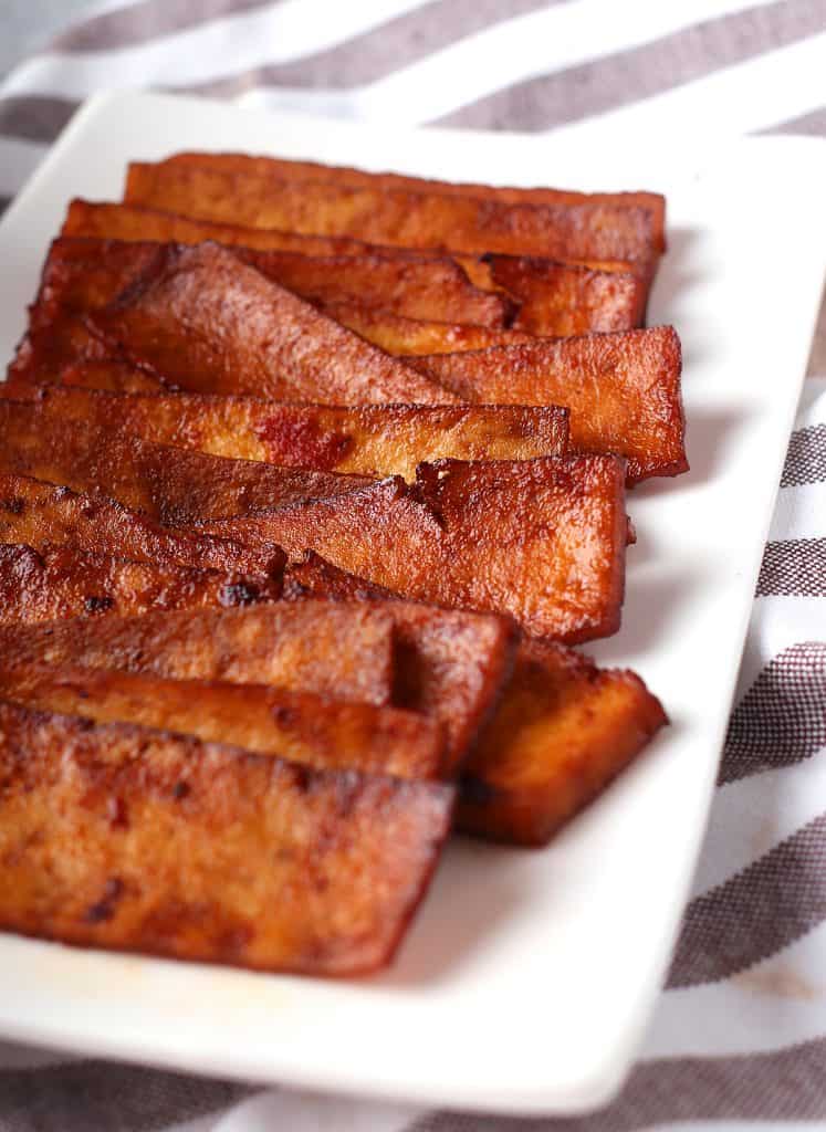 Strips of vegan bacon on a white plate