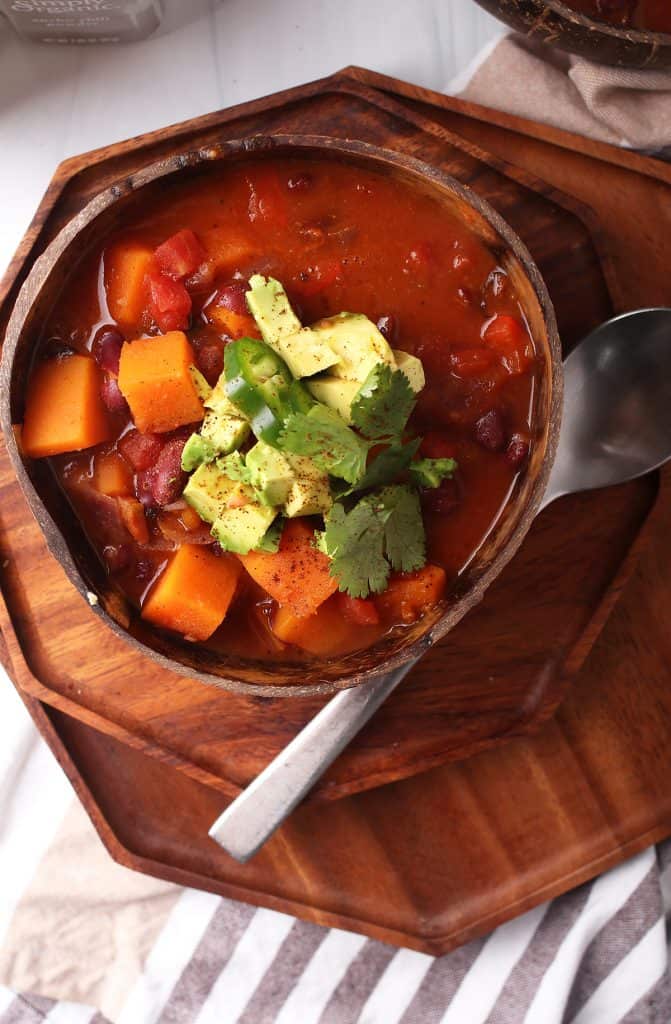 Bowl of finished chili with cilantro and avocado