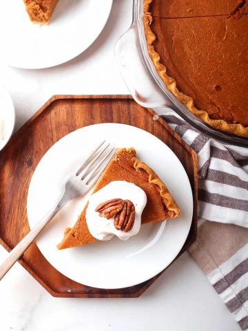 Slice of finished pie on a white plate with a fork