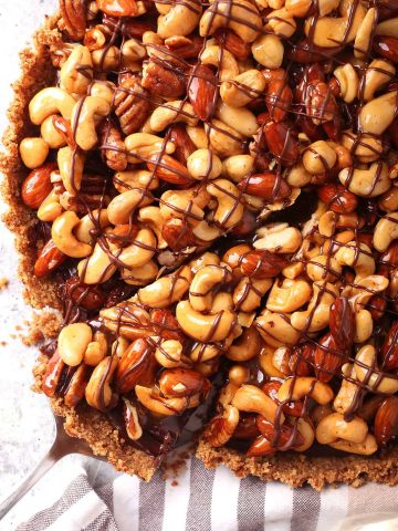 Close up of finished chocolate tart with one slice removed