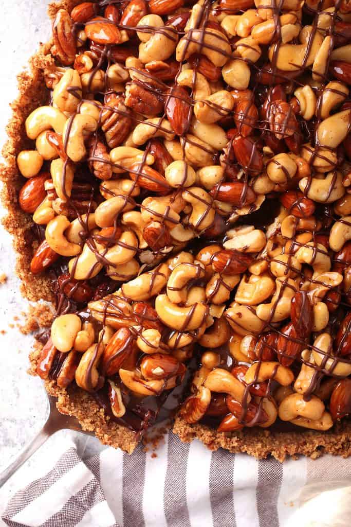 Close up of finished chocolate tart with one slice removed