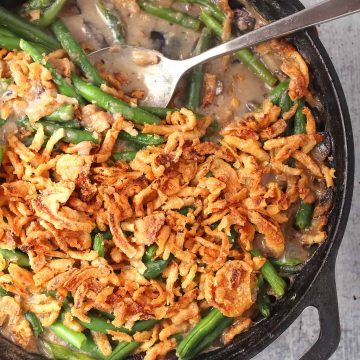 Finished green bean casserole in a cast iron skillet