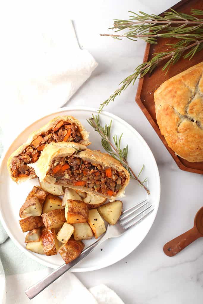 top view of vegan lentil wellington on a plate with potatoes