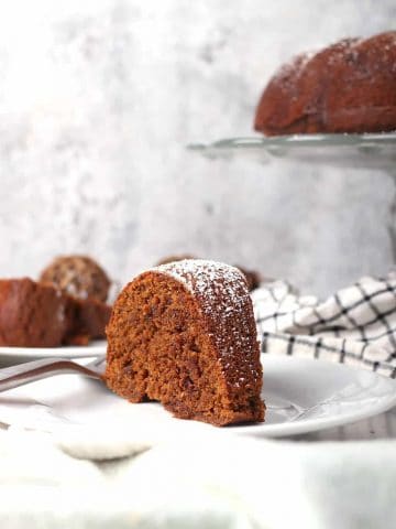 Slice of finished gingerbread cake on a white plate