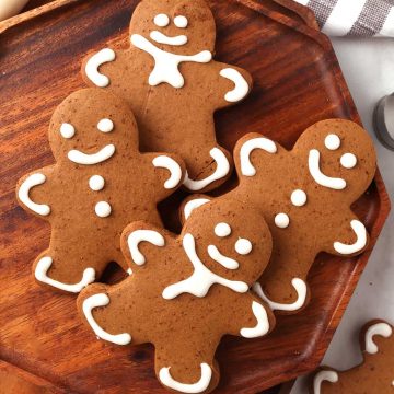 Finished gingerbread cookies on a wooden platter