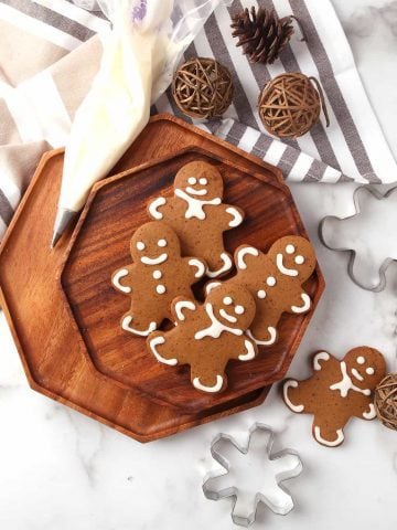 Finished gingerbread cookies on a wooden platter