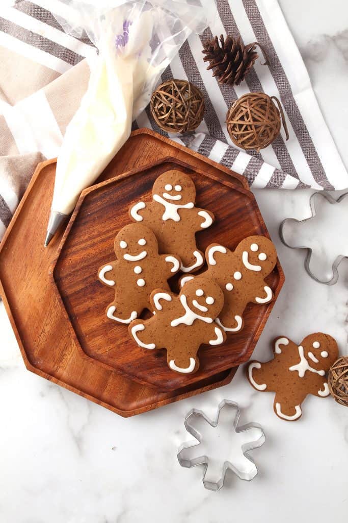 Finished gingerbread cookies on a wooden platter