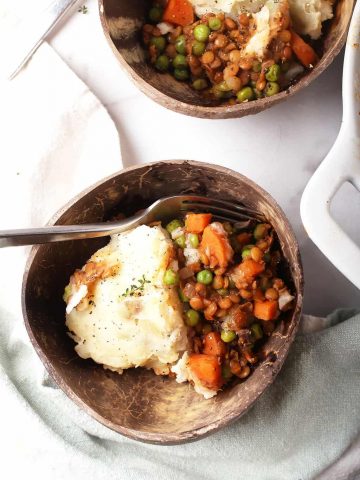 Two servings of shepherd's pie served in two bowls.