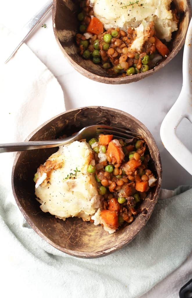 Two servings of shepherd's pie served in two bowls.