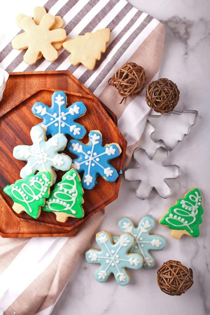 Christmas shaped sugar cookies on a wooden platter