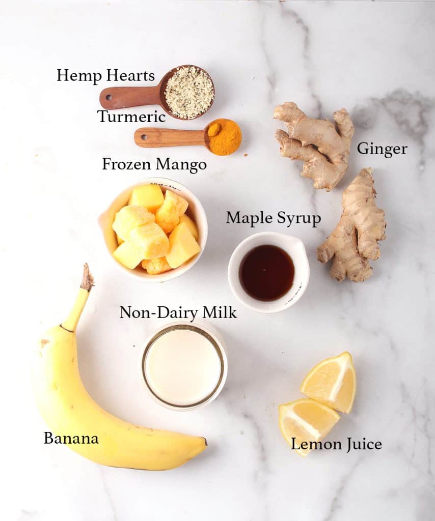 Ingredients for mango smoothie on a marble board