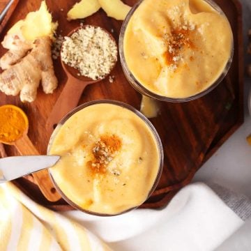 Finished smoothies in two glasses on a wooden board