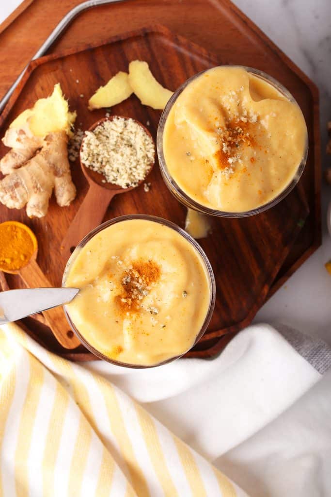 Finished smoothies in two glasses on a wooden board