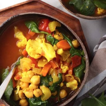 Bowl of vegetable soup in a coconut bowl