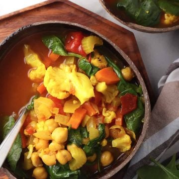 Bowl of vegetable soup in a coconut bowl