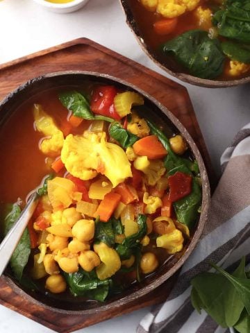 Bowl of vegetable soup in a coconut bowl