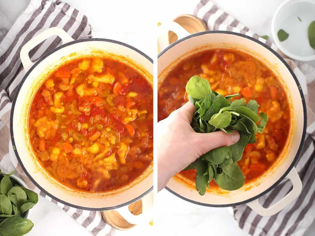 Finished soup in a white soup pot with fresh spinach