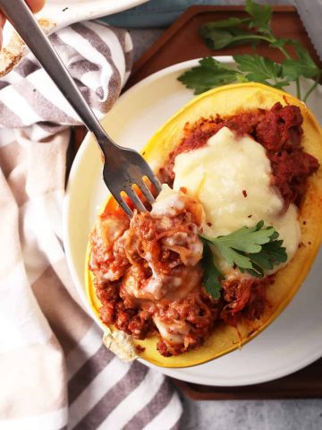 Finished stuffed spaghetti squash with a fork