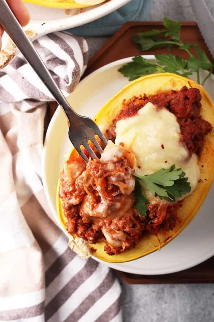 Finished stuffed spaghetti squash with a fork