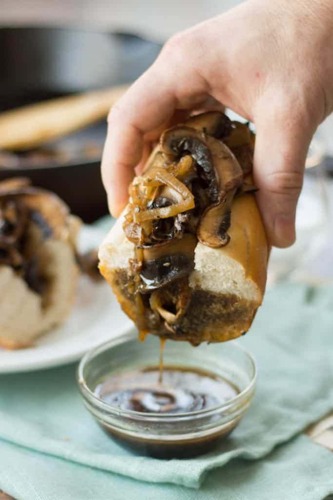 French Dip sandwich dipped into savory sauce