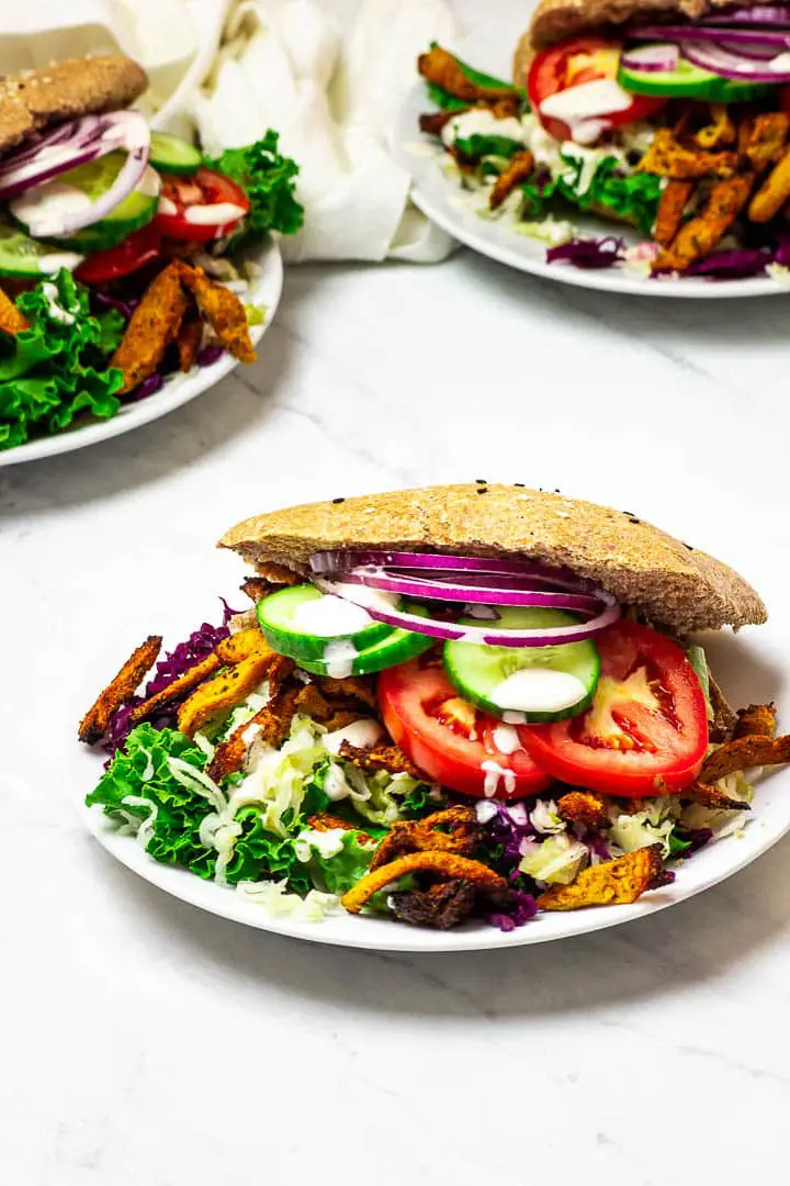 Vegan Doner Kabab on a white plate with a salad