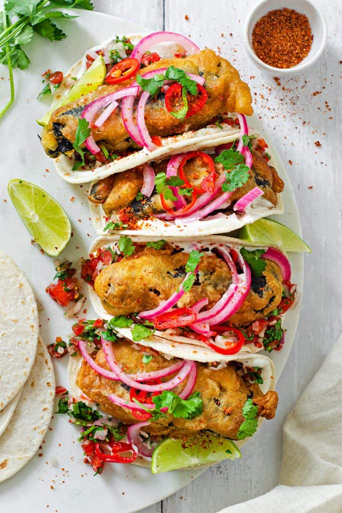 Vegan Baja "Fish" Tacos on a rounded white plate.