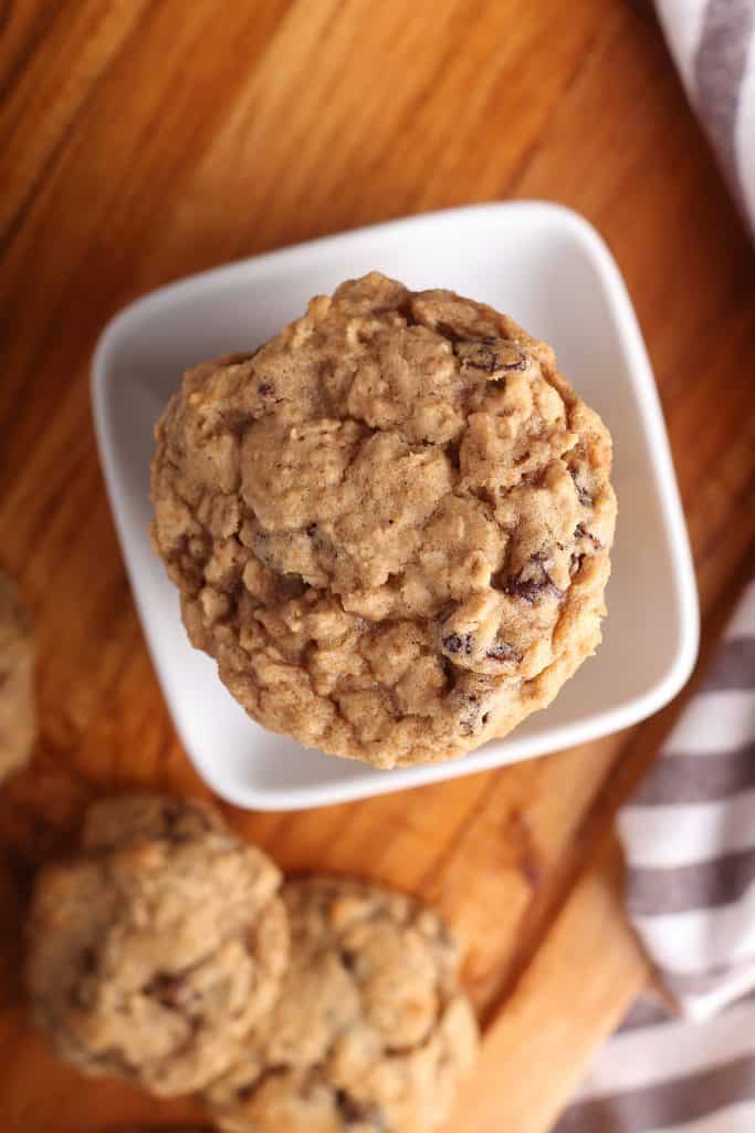 Overhead shot of oatmeal raisin cookies in a white bowl. 