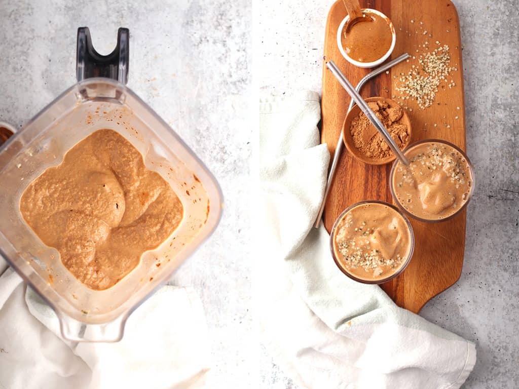 overhead shot of a blender filled with chocolate breakfast smoothie next to a cutting board with two glasses of chocolate smoothie