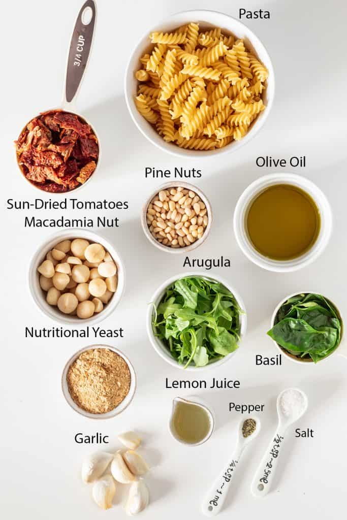 ingredients for vegan pesto pasta recipe measured out into white bowls