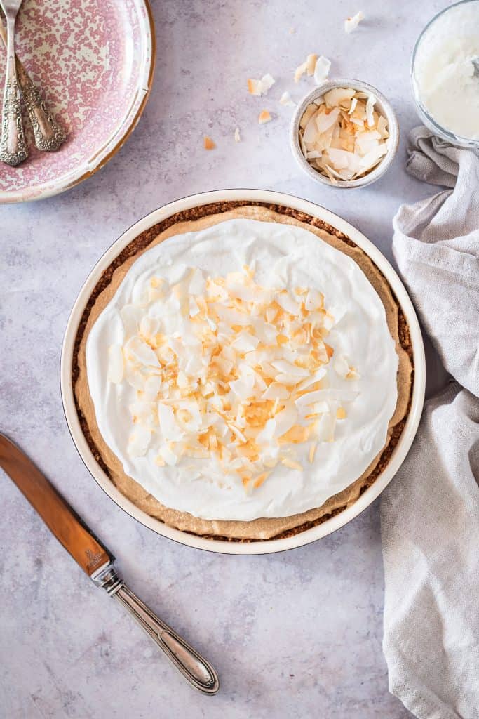 healthy, vegan coconut cream pie topped with coconut chips