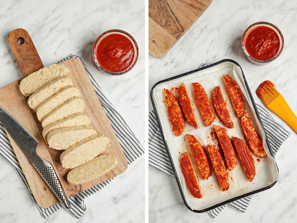 Chopped tempeh basted generously with sauce on one side in a baking tray.