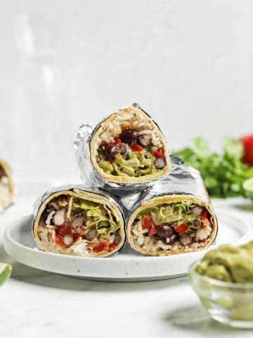 three burritos on white plate