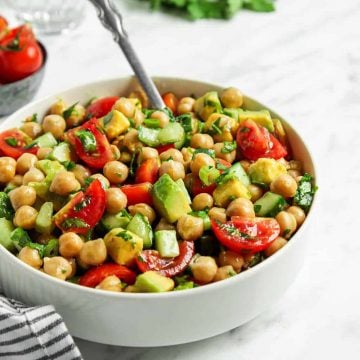 Front view of chickpea salad in white bowl