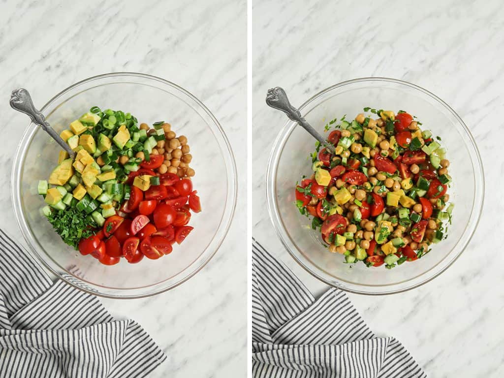 top view of tomatoes, avocado, parsley, chickpeas, cucumber, green onions, and dressing in bowl