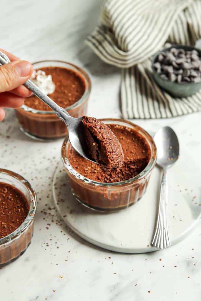 vegan chocolate mousse in glass with spoonful of mousse