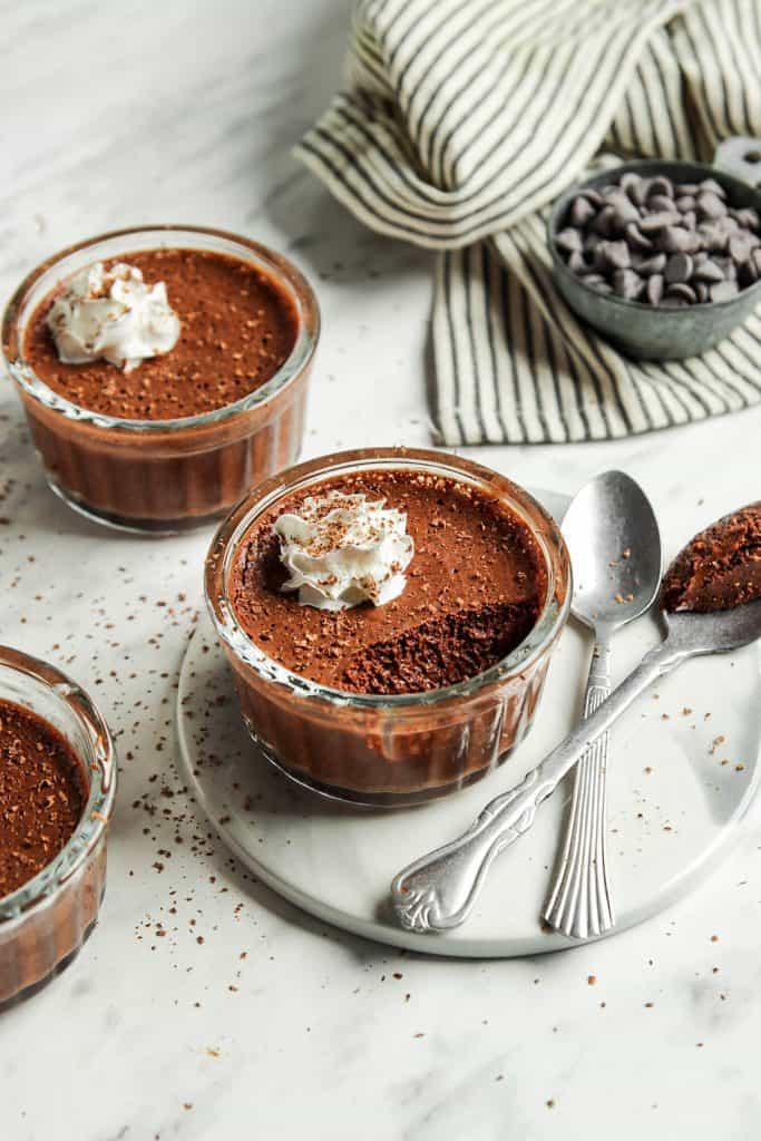 three glasses of vegan chocolate mousse with two spoons