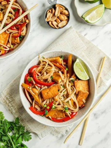 one white bowl filled with pad Thai noodles